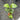 A small green leafy plant in a tiny orange pot, photographed from above on a black perforated mesh tray. Two thin support wires run vertically through the center, and other black nursery pots are visible in the background.